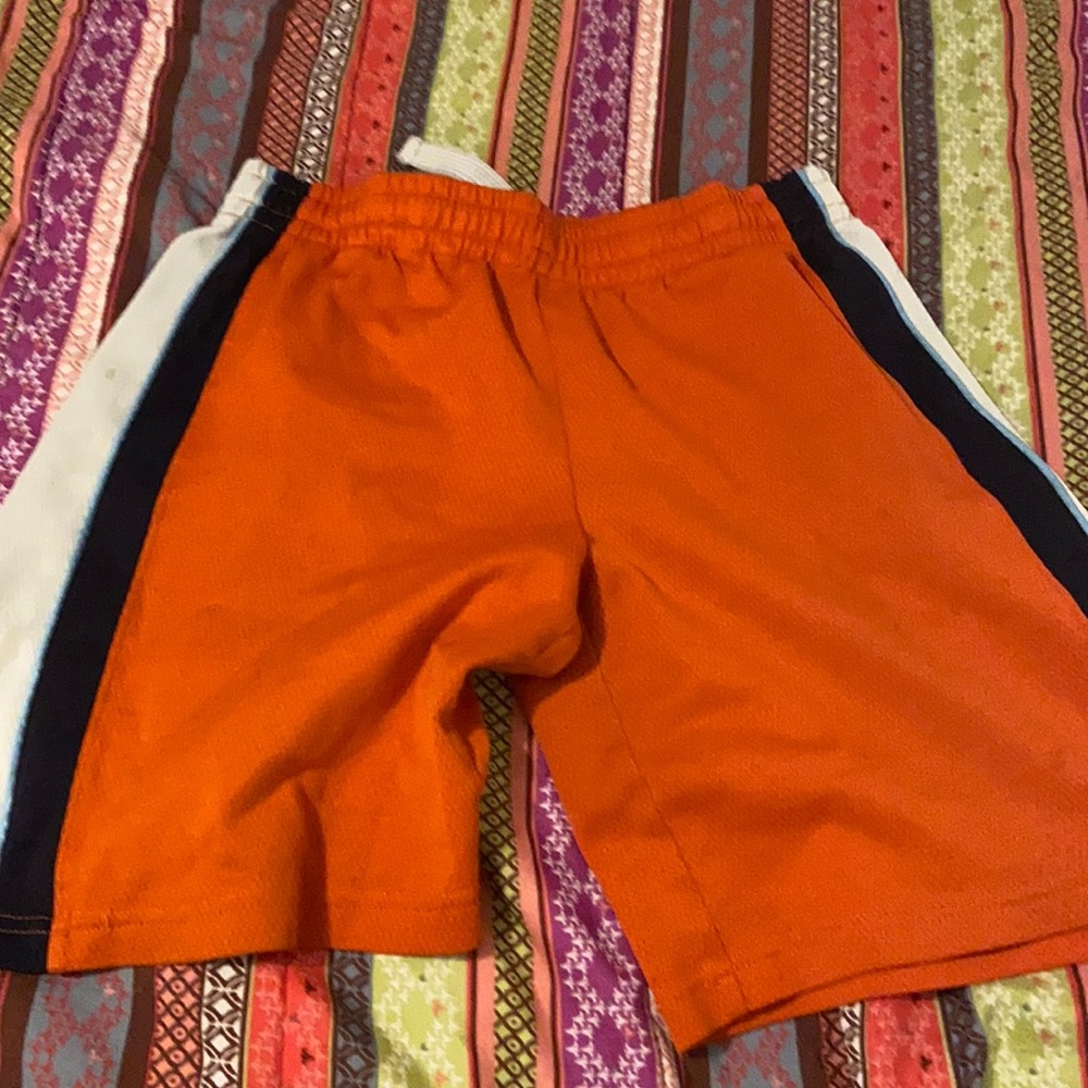 Orange athletic sleeveless top and shorts